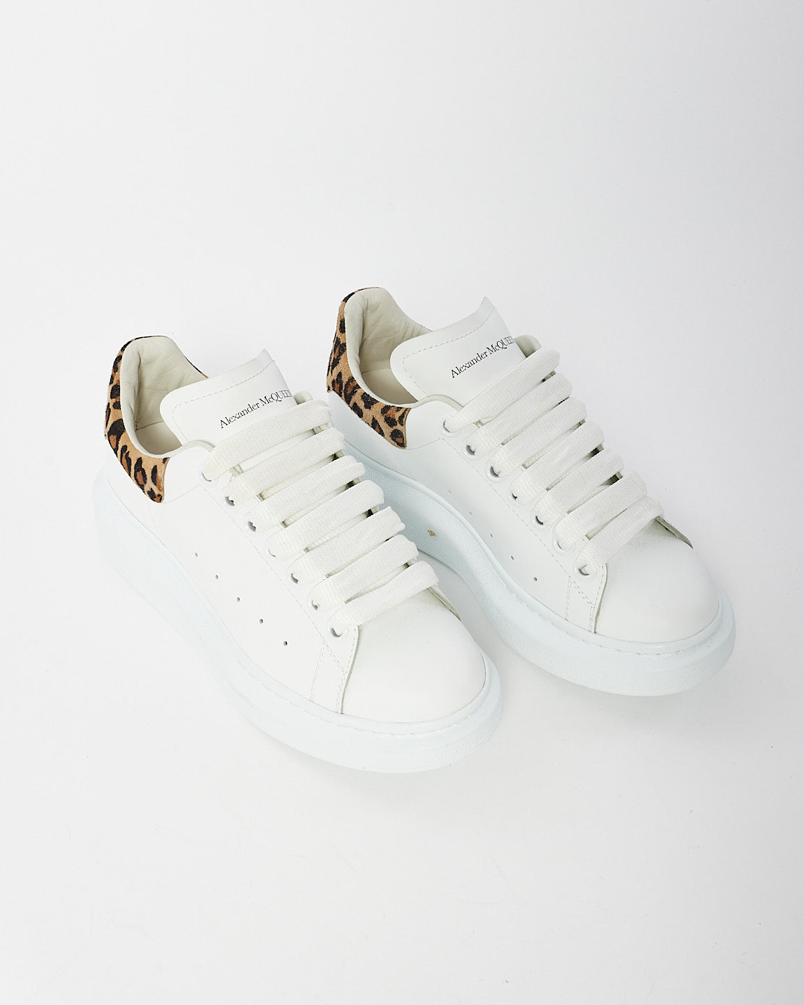 Explore a Alexander McQueen White Leopard Oversized Sneaker