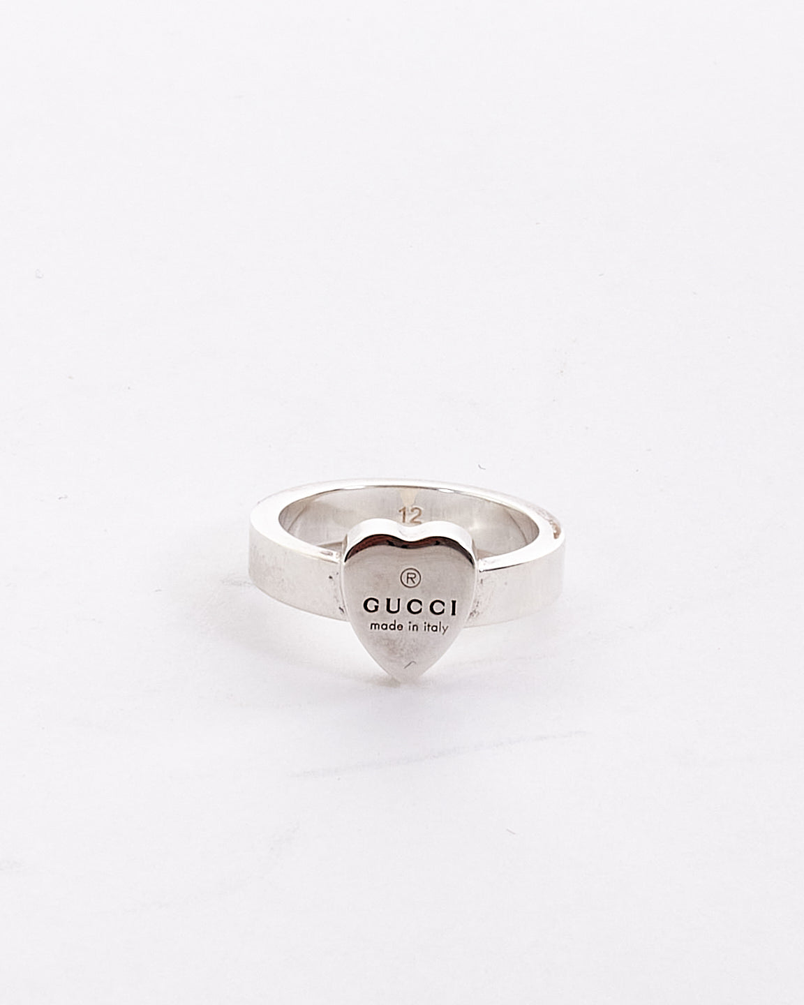 Explore a Gucci Silver Trademark Ring with Heart Pendant