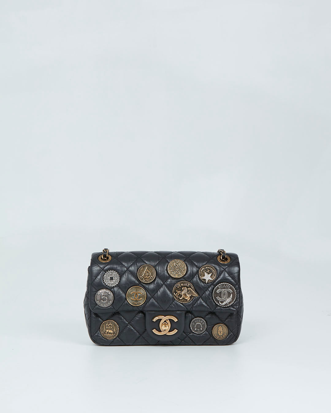 Explore a Chanel Black Aged Calfskin Coin Medallion Mini Flap Bag