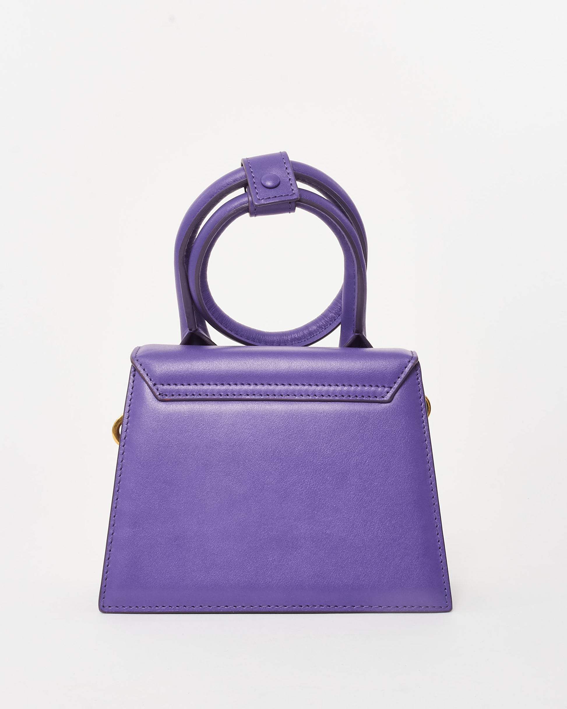 Jacquemus Pre-Owned Le Chiquito Noeud mini handbag in vibrant violet leather, featuring a structured trapezoidal silhouette, circular top handles, and gold-tone logo detailing, back view.