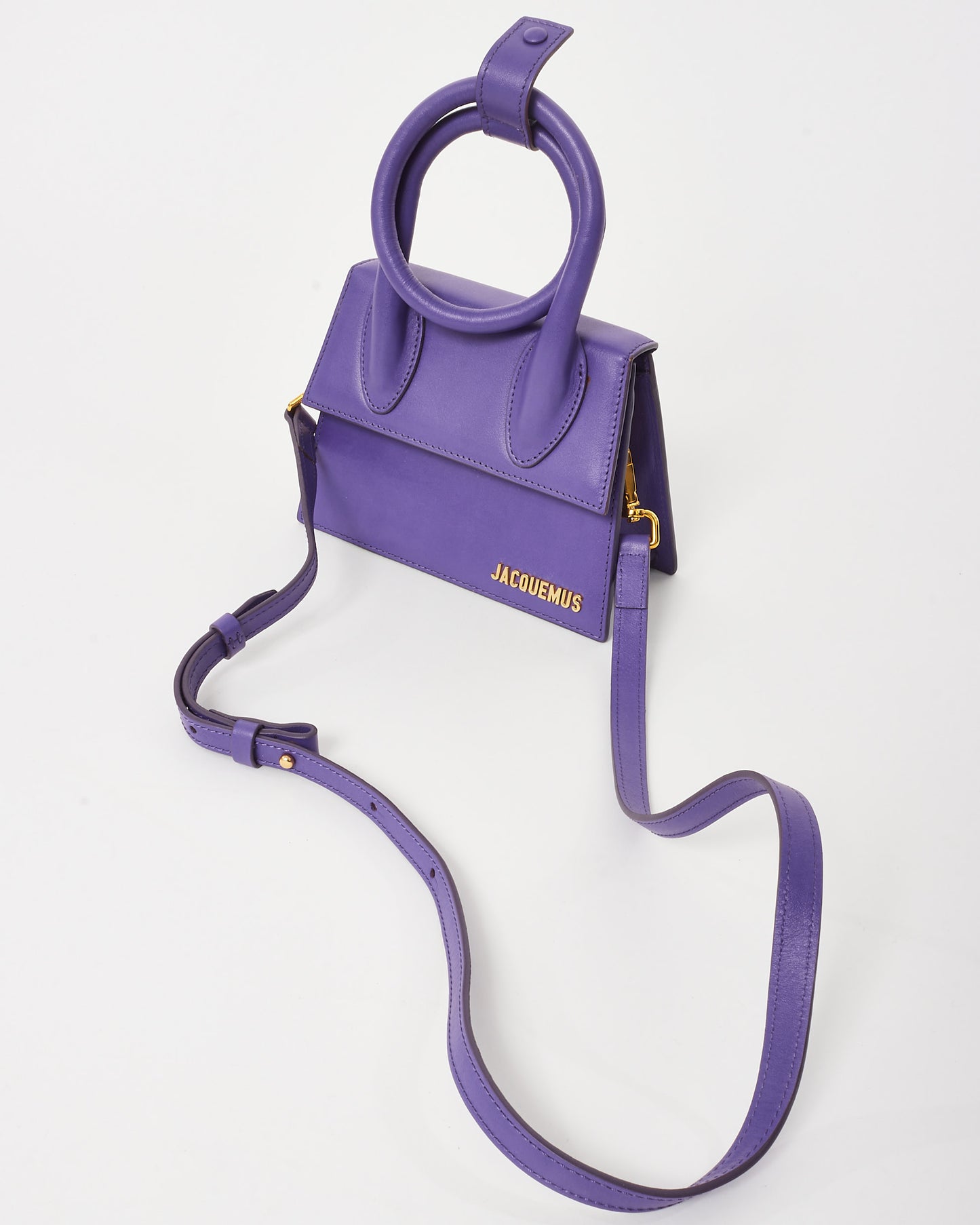 Pre-owned Jacquemus Le Chiquito Noeud mini handbag in vibrant violet leather, featuring a structured trapezoidal silhouette, circular top handles, and gold-tone logo detailing, top view.